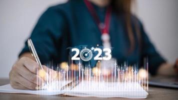 Business and Technology target set goals and achievement in 2023 new year resolution statistics graph rising revenue, planning to start up strategy, icon concept photo