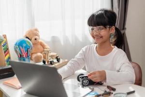 Asia students learn at home in coding robot cars and electronic board cables in STEM, STEAM, mathematics engineering science technology computer code in robotics for kids concept. photo