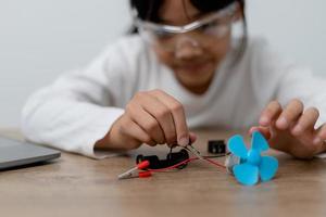 Asia students learn at home in coding robot cars and electronic board cables in STEM, STEAM, mathematics engineering science technology computer code in robotics for kids concept. photo