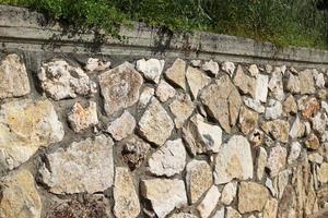 High wall made of stone and concrete. photo