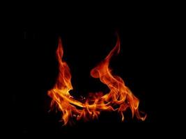 A beautiful flame shaped as imagined. like from hell, showing a dangerous and fiery fervor, black background. photo