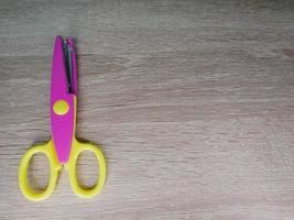 Children's wavy-patterned paper scissors to use in various inventions. photo