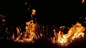 Haystack fires at night in arid areas The ash erupted and the wind was very dangerous. ashes red as hell. photo