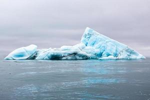 A blue Iceberg floating in the sea in Svalberg photo