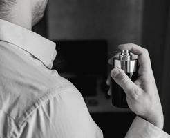 young man using perfume photo