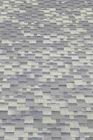 Background mosaic texture of flat roof tiles with bituminous coating photo