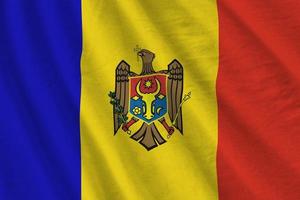 Moldova flag with big folds waving close up under the studio light indoors. The official symbols and colors in banner photo