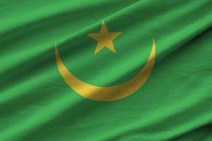 Mauritania flag with big folds waving close up under the studio light indoors. The official symbols and colors in banner photo