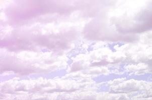 A blue sky with lots of white clouds of different sizes photo