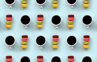 A pattern of many colorful dessert cake macaroon and coffee cups on trendy pastel blue background top view. Flat lay composition photo