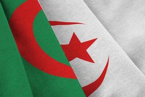 Algeria flag with big folds waving close up under the studio light indoors. The official symbols and colors in banner photo
