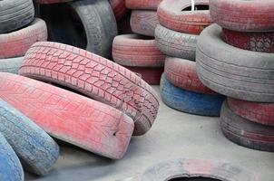 A picture of many old used tires left on a waste dump photo