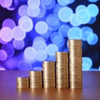 Golden coin stacks arranged as a graph. Increasing columns of coins photo