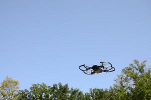 Drone with photocamera take off from land and flying for take aerial photo
