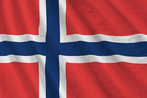 Norway flag with big folds waving close up under the studio light indoors. The official symbols and colors in banner photo