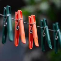 Clothespins on a rope hanging outside house and apple tree photo