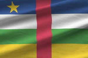 Central African Republic flag with big folds waving close up under the studio light indoors. The official symbols and colors in banner photo