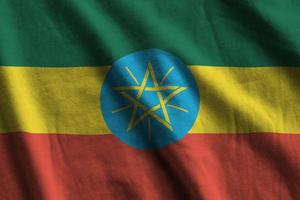 Ethiopia flag with big folds waving close up under the studio light indoors. The official symbols and colors in banner photo