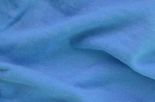 The texture of the fabric in blue color. Material for making shirts and blouses photo