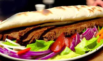 Shawarma. Doner kebab, fresh vegetables and meat. Kebab sandwich close up. photo