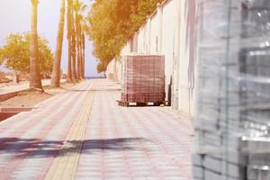 Paving stones on wooden pallet on the street sidewalk photo