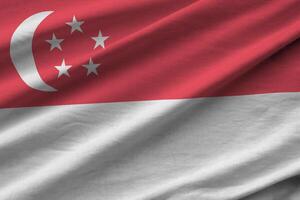 Singapore flag with big folds waving close up under the studio light indoors. The official symbols and colors in banner photo