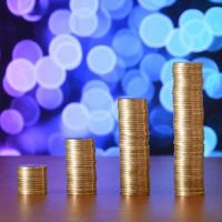 Golden coin stacks arranged as a graph. Increasing columns of coins photo