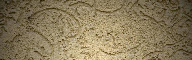 The texture of the beige decorative plaster in bark beetle style photo