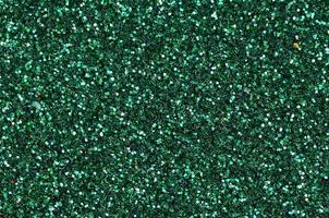 Colorful defocused emerald green background with glittering and sparkling spots photo