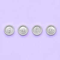 Many metallic beer cans on texture background of fashion pastel violet color paper in minimal concept photo