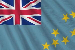 Tuvalu flag with big folds waving close up under the studio light indoors. The official symbols and colors in banner photo