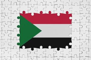 Sudan flag in frame of white puzzle pieces with missing central part photo