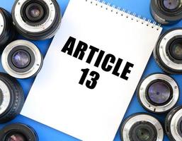 Two photographic lenses and notebook with article 13 inscription photo