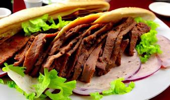 Shawarma. Doner kebab, fresh vegetables and meat. Kebab sandwich close up. photo