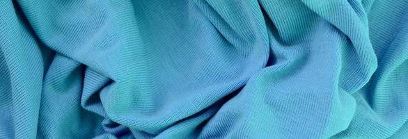 The texture of the fabric in blue color. Material for making shirts and blouses photo