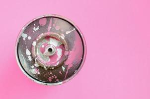 Used spray can with pink paint drips lie on texture background of fashion pastel pink color paper in minimal concept photo