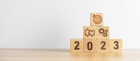 2023 wood block with business goal, plan. Action strategy, target, mission, teamwork, idea and New Year start concept photo