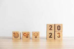 2023 wood block with business goal, plan. Action strategy, target, mission, teamwork, idea and New Year start concept photo