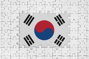 South Korea flag in frame of white puzzle pieces with missing central part photo