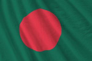 Bangladesh flag with big folds waving close up under the studio light indoors. The official symbols and colors in banner photo