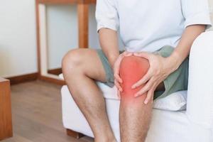 Man having knee ache and muscle pain due to Runners Knee or Patellofemoral Pain Syndrome, osteoarthritis, arthritis, rheumatism and Patellar Tendinitis. medical concept photo