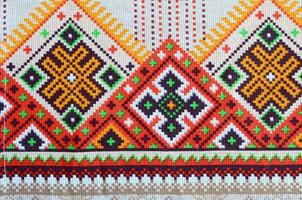 Traditional Ukrainian folk art knitted embroidery pattern on textile fabric photo