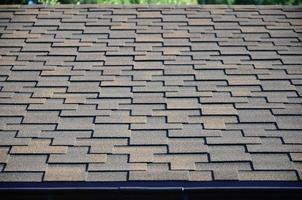 Modern roofing and decoration of chimneys. Flexible bitumen or slate shingles photo