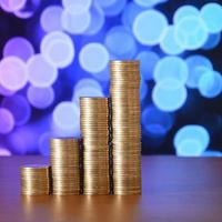 Golden coin stacks arranged as a graph. Increasing columns of coins photo
