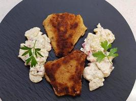 Red Snapper Sebastes norvegicus fish filet with potato salad photo