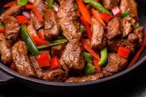 Delicious Asian teriyaki meat with red and green bell peppers photo