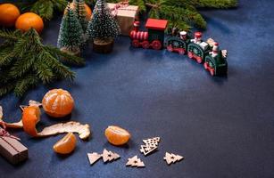 Delicious festive New Year's pie with candied fruits, marzipan and nuts on a dark concrete background photo