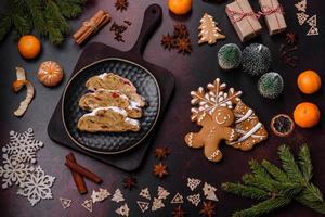 Christmas pie stollen with marzipan, berries and nuts on a dark concrete background photo