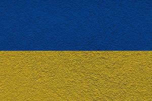 Ukrainian state national flag. Texture concrete grunge wall in yellow-blue color. State symbol of Ukraine and Ukrainians. Ukrainian flag on a concrete wall background. photo