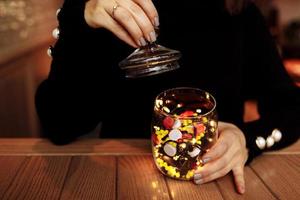 young woman showing bottle of medicine. colored capsules. Different medicinal capsule spill out of a glass. medicine concept photo